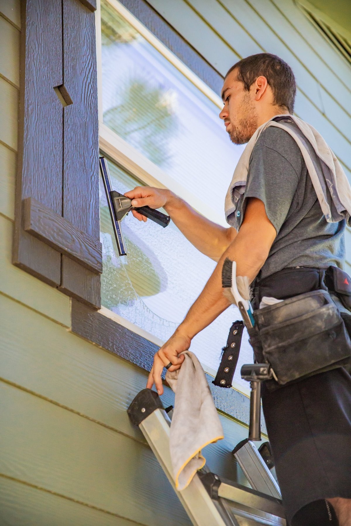 MG Cleaning Systems technician working on exterior cleaning